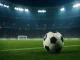 Pallone da calcio su un campo illuminato in uno stadio notturno pieno di tifosi, simbolo delle scommesse a lungo termine sul calcio 2025.